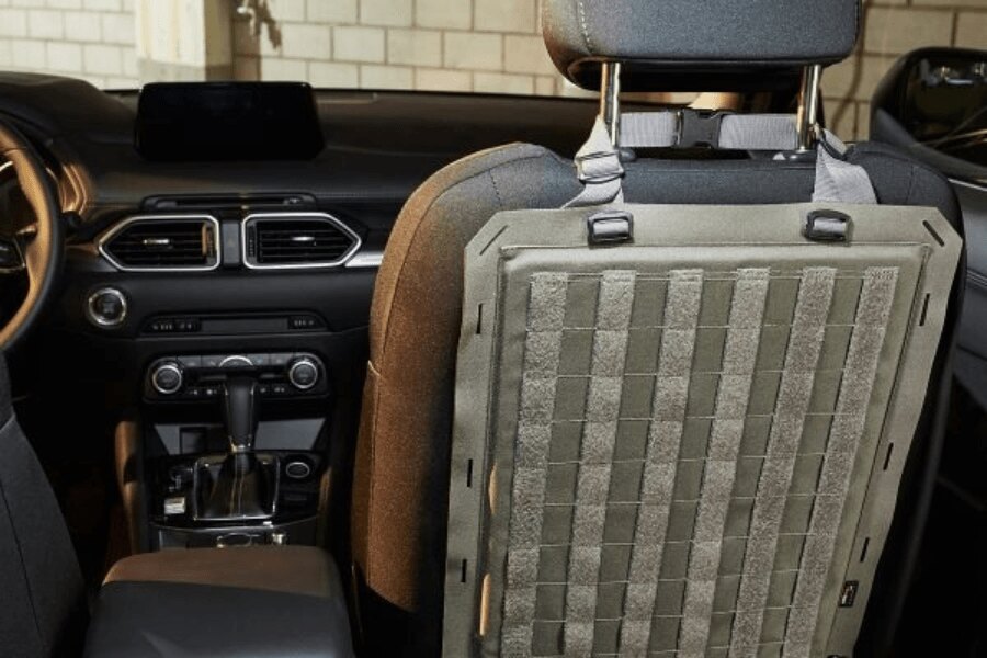 Panel taktyczny MOLLE TacVec Auto Front Seat Tasmanian Tiger zamocowany na tylnej stronie siedzenia samochodu.
